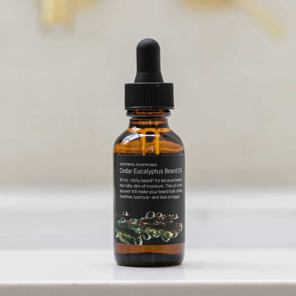 Saltspring Soapworks Cedar Eucalyptus Beard Oil on a white surface with a blurred background