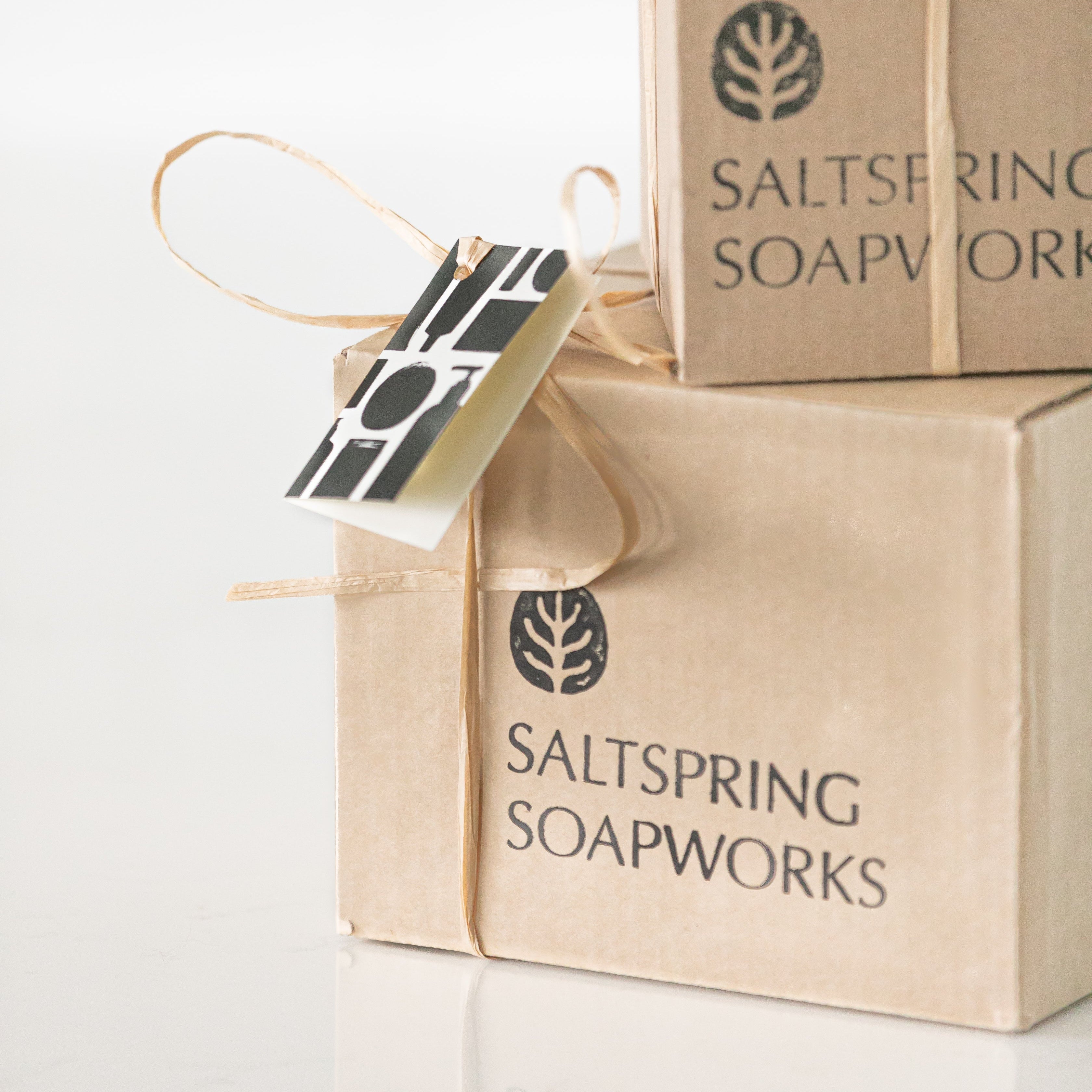 Two boxes from Saltspring Soapworks with a tag on a white background