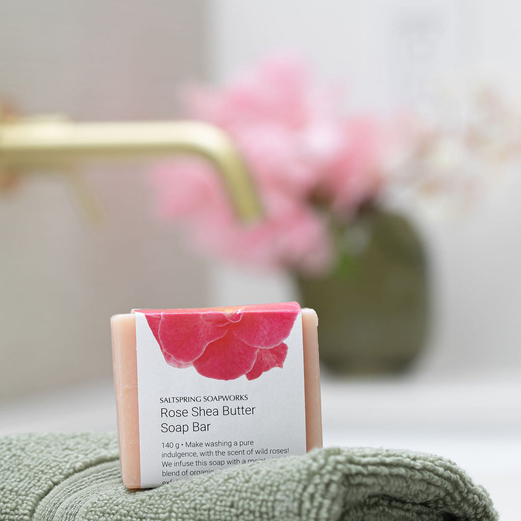 Saltspring Soapworks Rose Shea Butter Soap Bar on a green towel in a bathroom setting