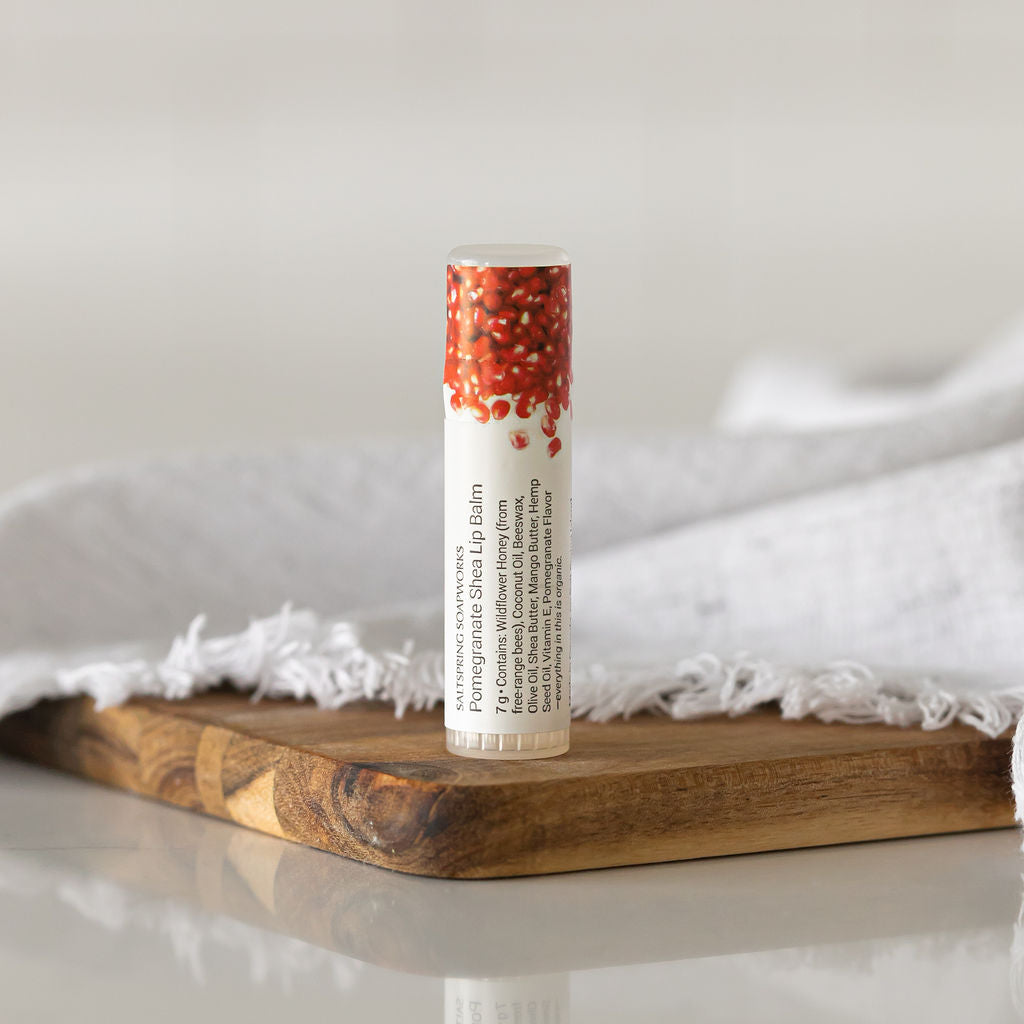 Saltspring Soapworks Pomegranate Lip Balm on wooden tray