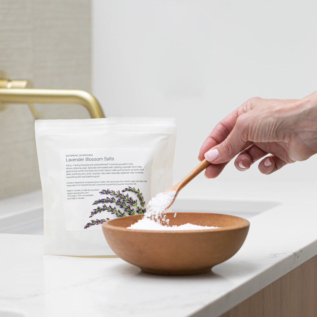 Saltspring Soapworks Lavender bath salts being scooped out of a wooden bowl