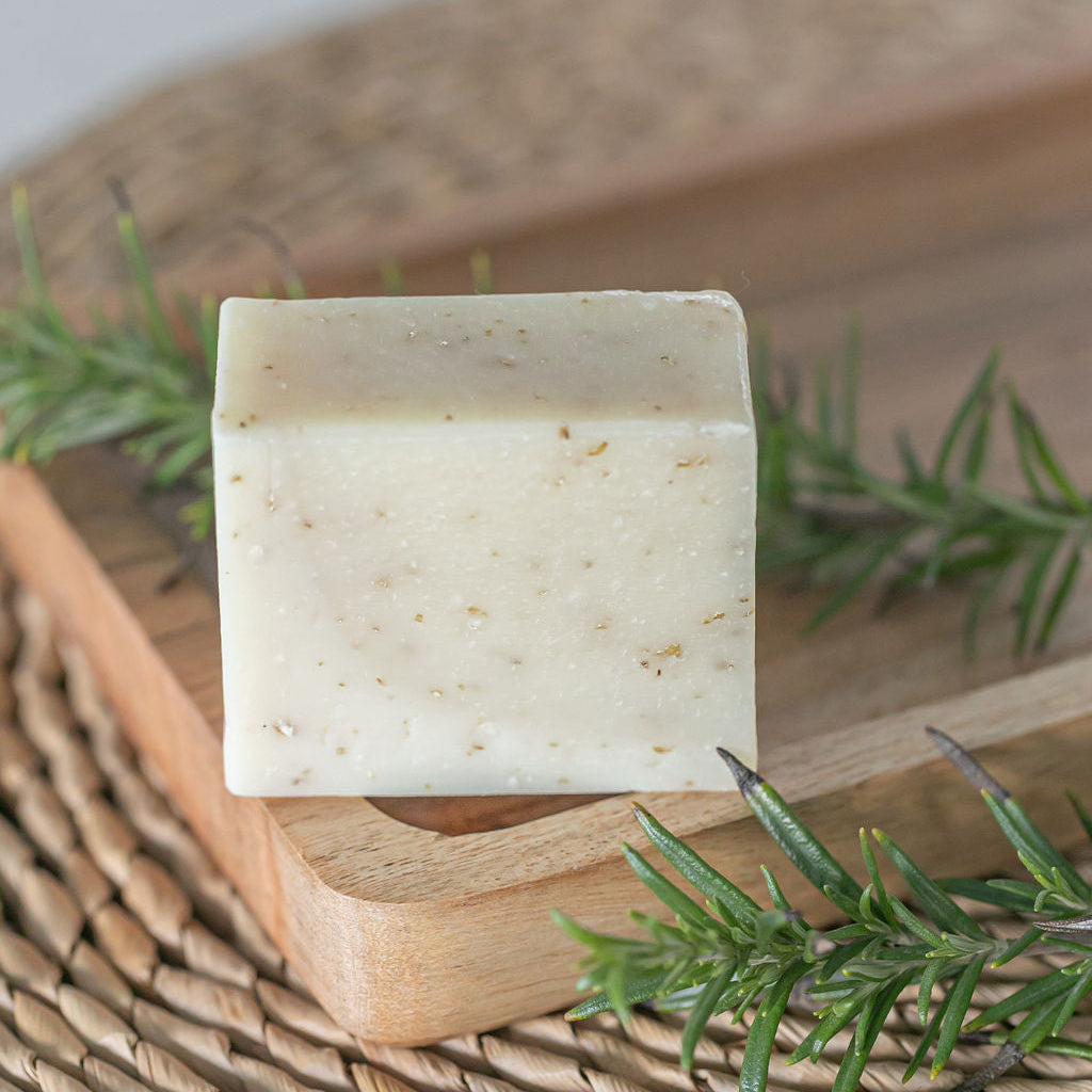 Saltspring Soapworks Rosemary Mint Soap Bar with fresh rosemary sprigs on wooden tray.
