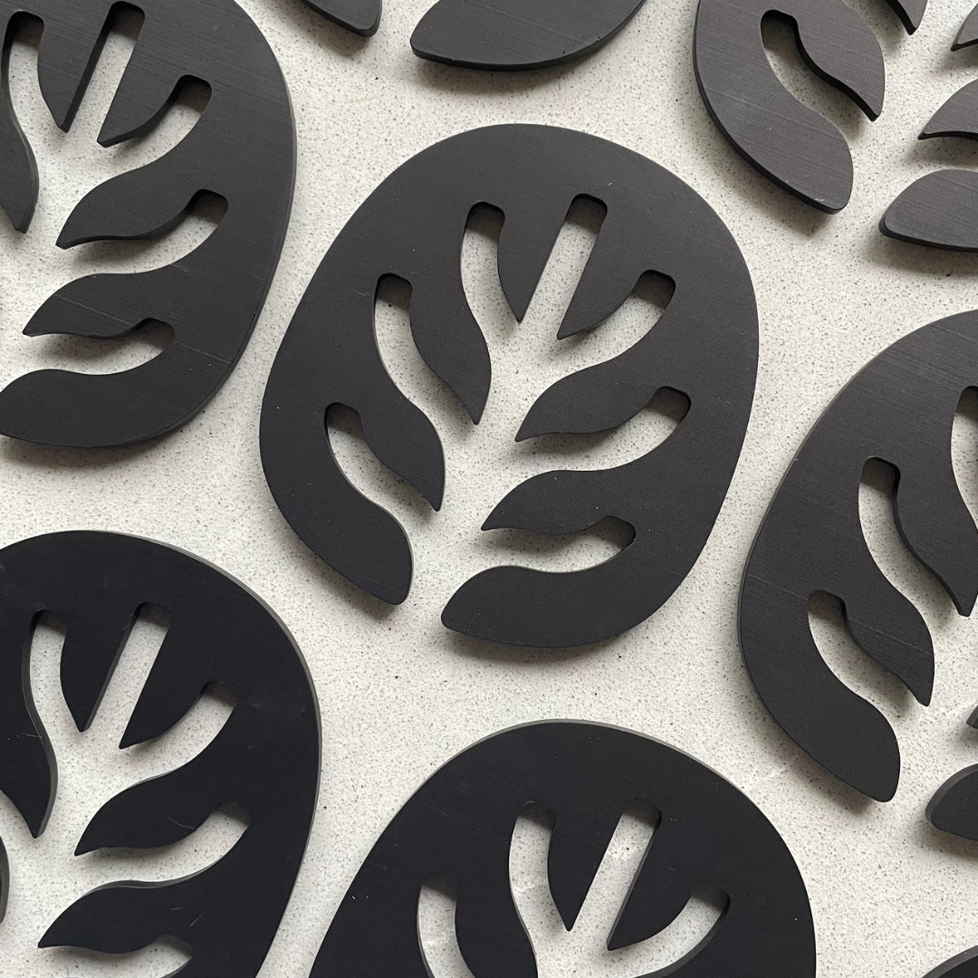 multiple black Saltspring Soapworks soap savers in a counter